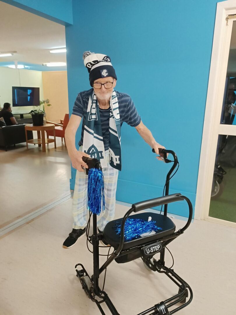 Graham proudly showing off his Carlton FC outfit in his SIL residence