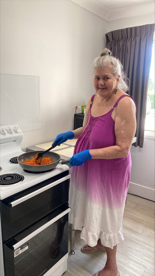 Kristina cooking a healthy meal in her SIL residence